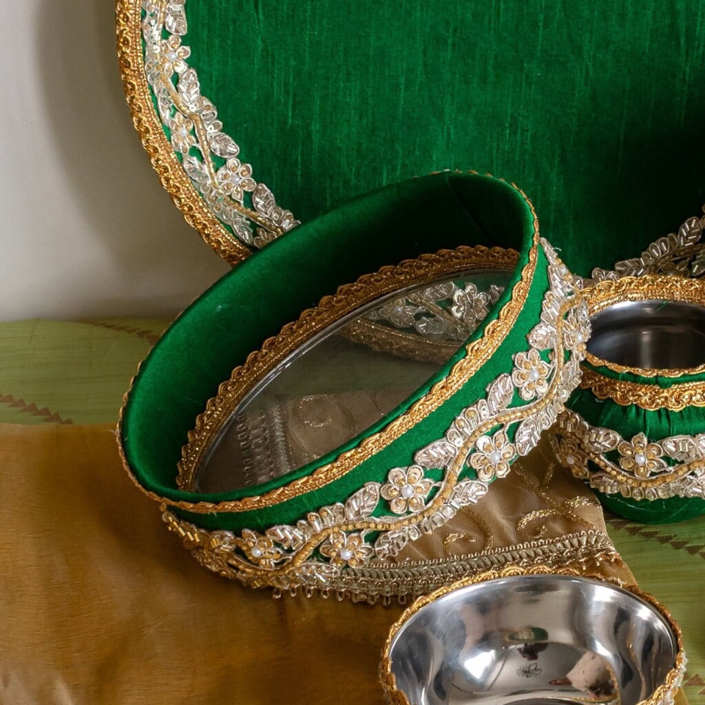 Floral Art presents A decorative green and gold tray set with silver bowls, featuring intricate floral embroidery and embellishments.